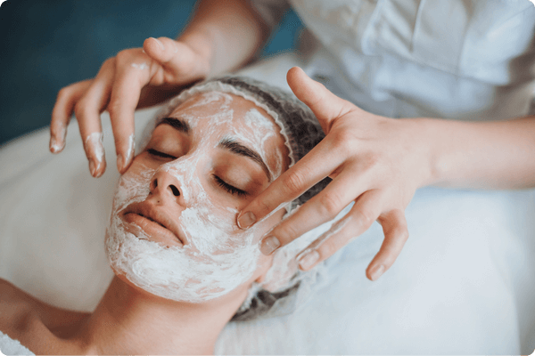 Skincare specialist applying face mask