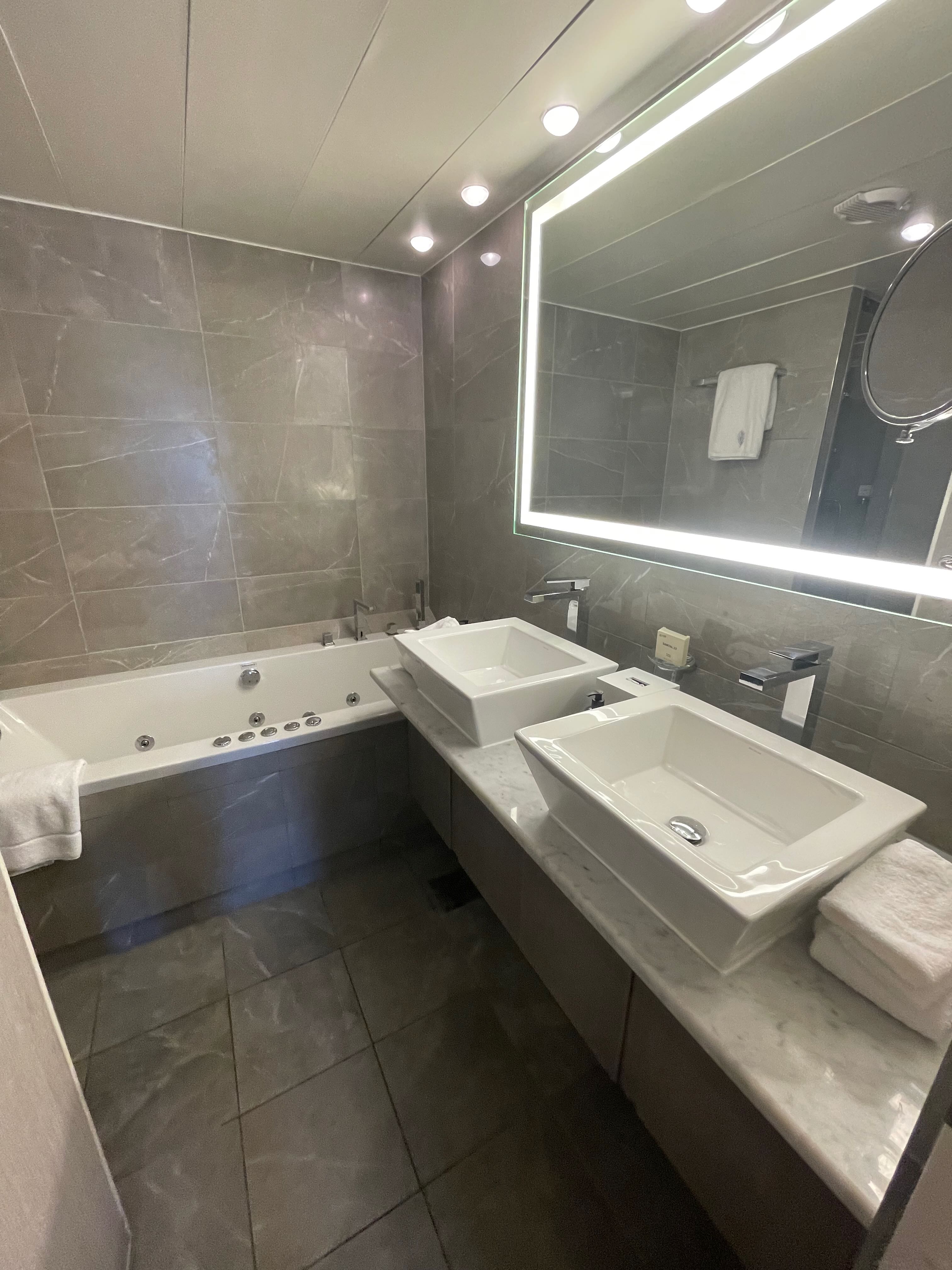 Royal Suite marble bathroom with double sinks and soaking tub