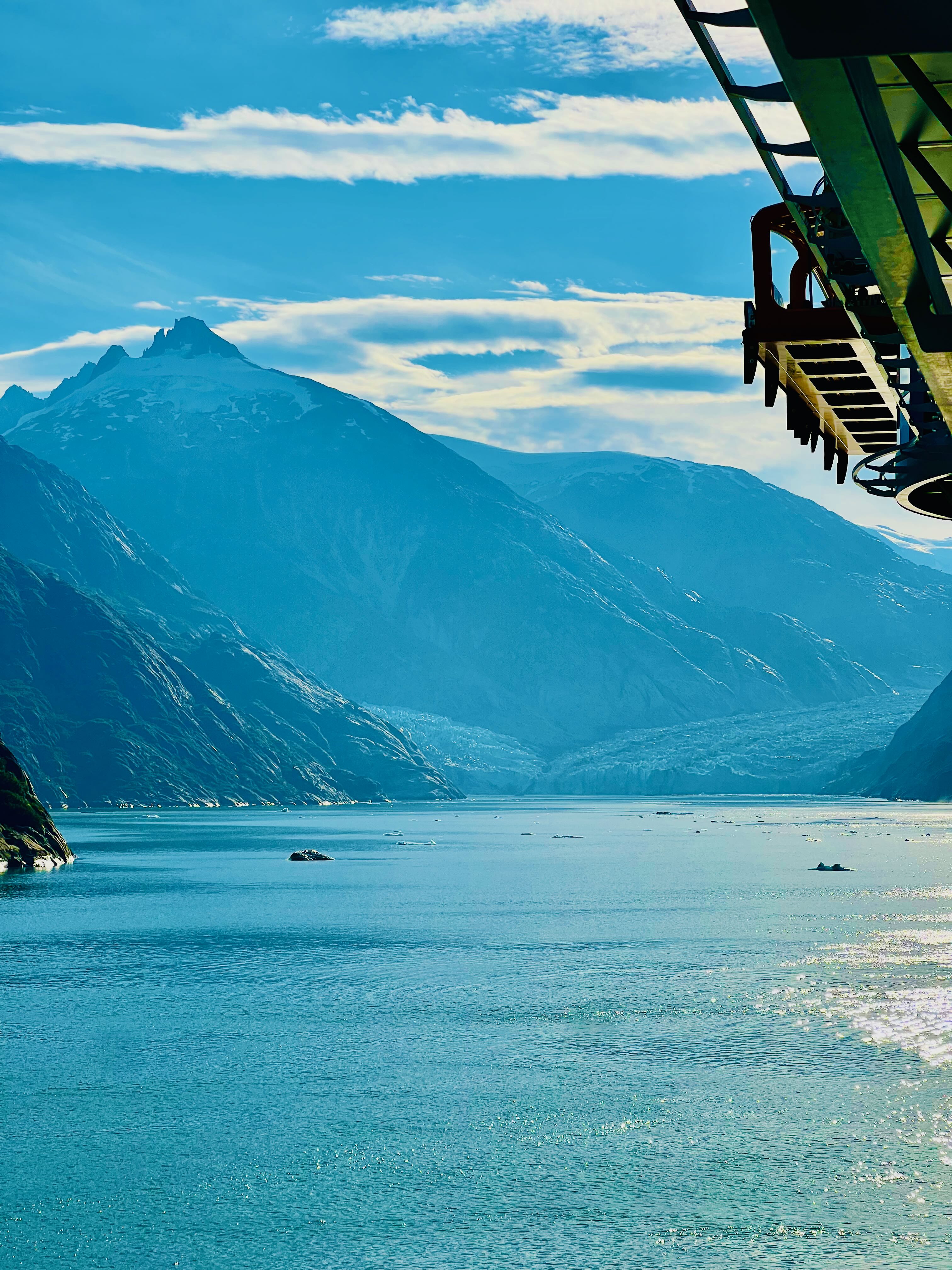Looking down fjord between two mountain walls with glacial blue-green water