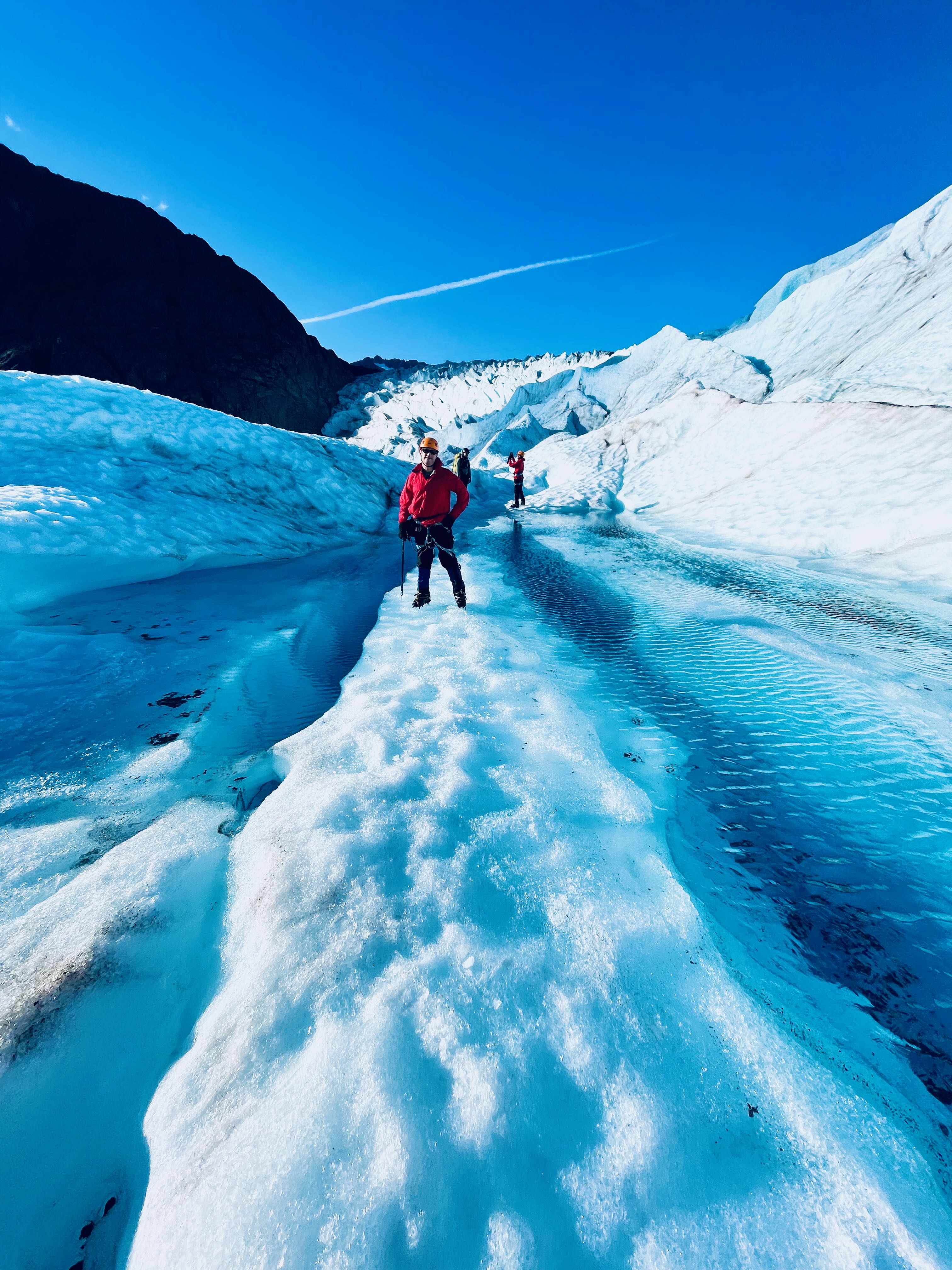 Patrick on narrow ice ridge between meltwater channels