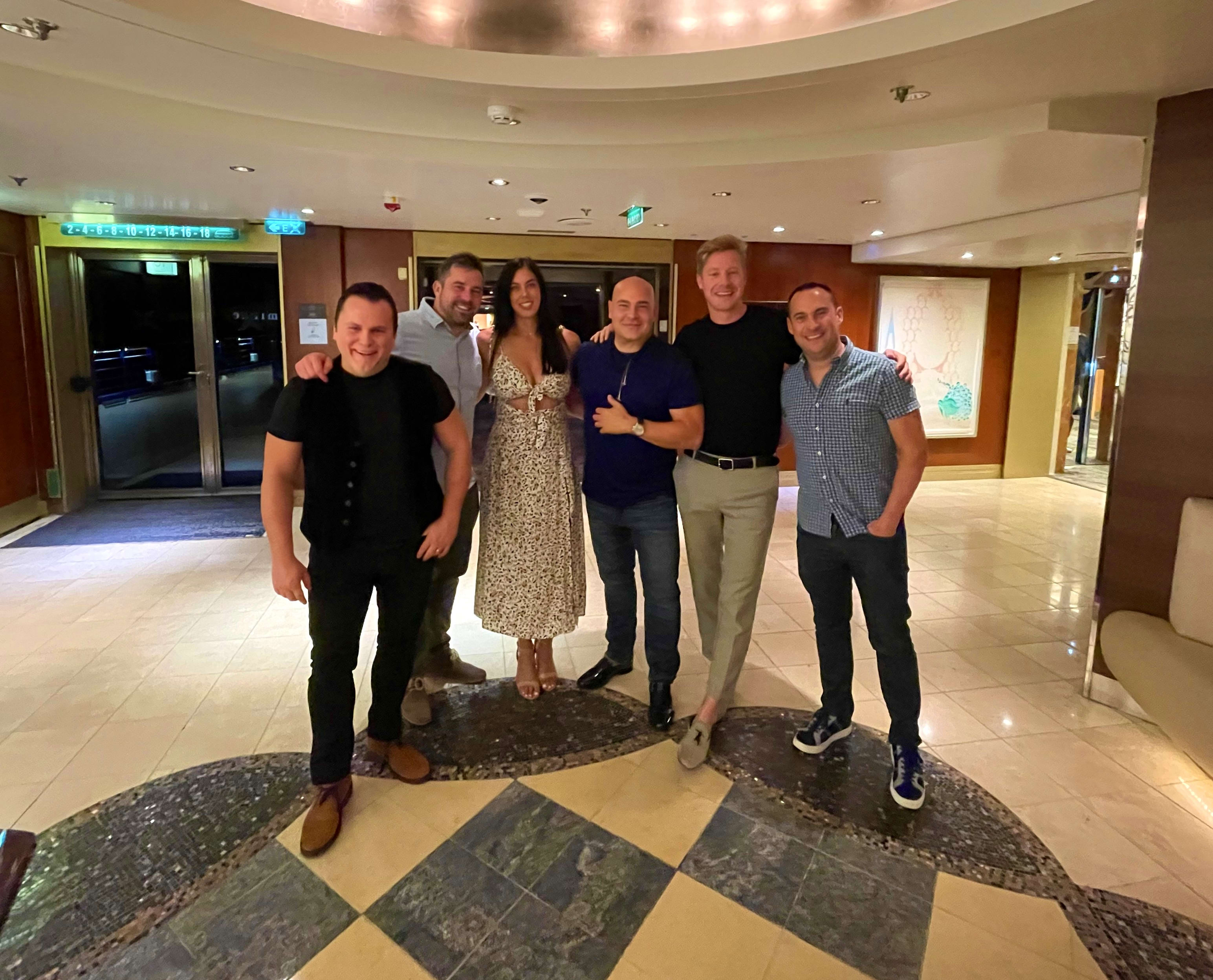 The full crew of six dressed for dinner in the ship atrium