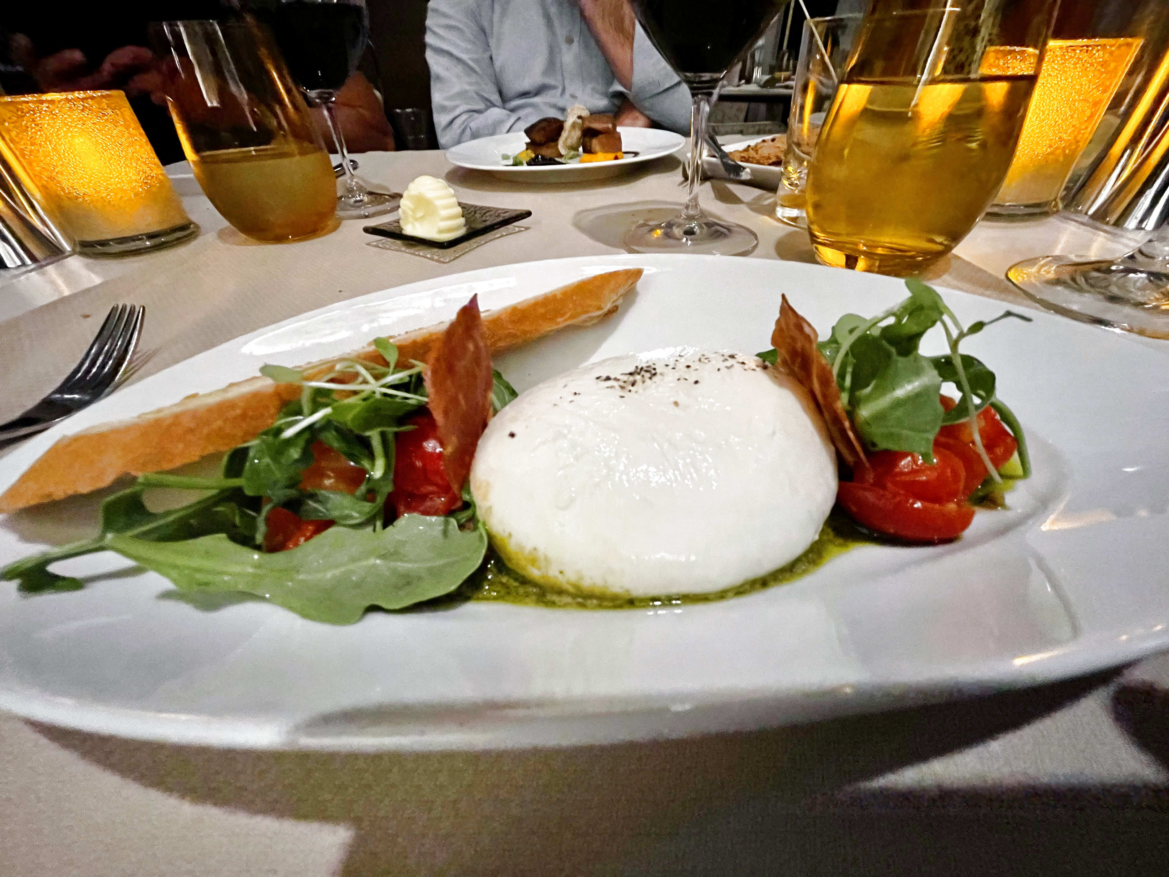 Luminae burrata with roasted tomatoes, arugula and pesto