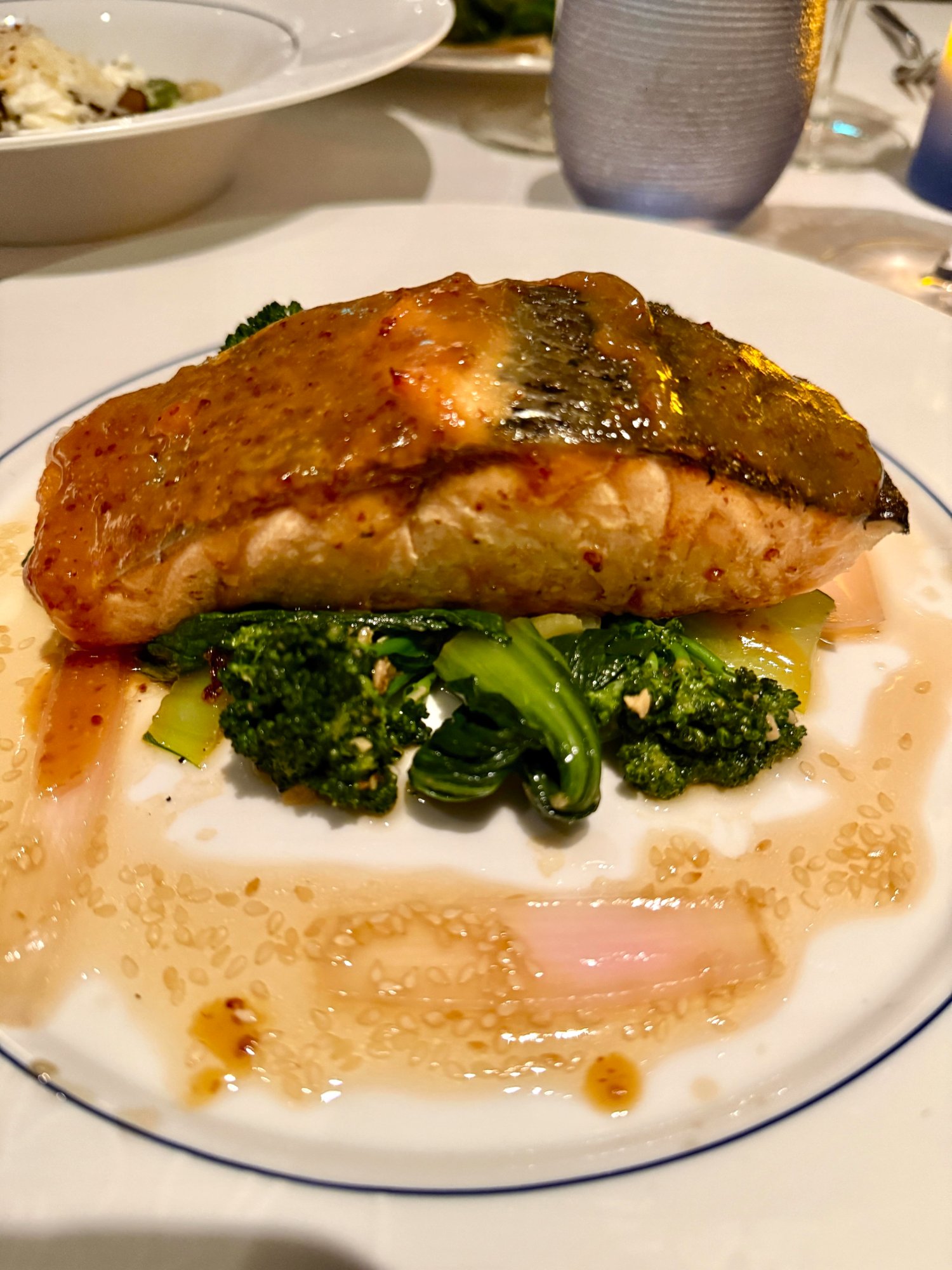 Blu glazed salmon over sesame-citrus broth with broccolini