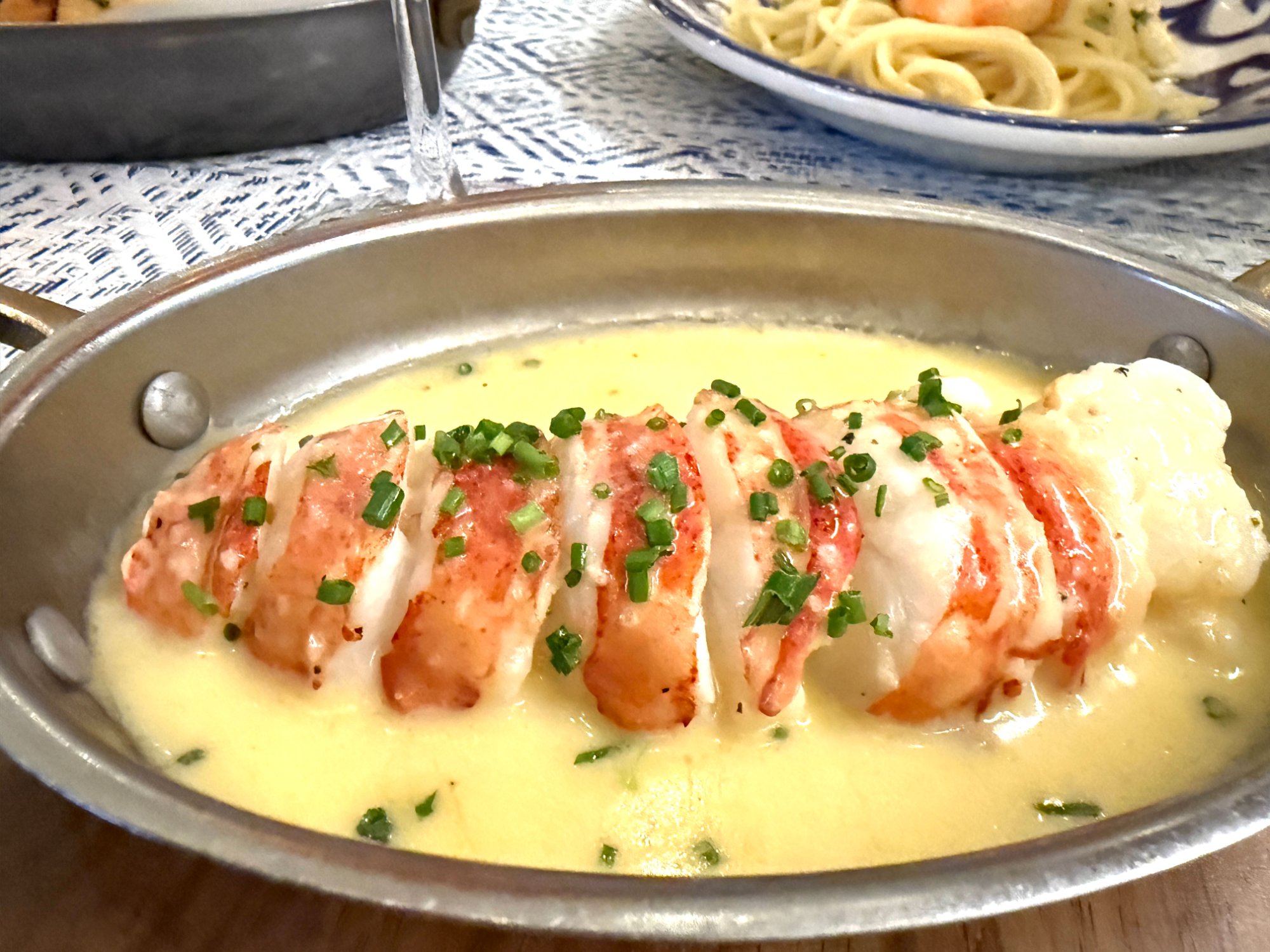 Bora dinner butter-poached lobster tail in silver pan