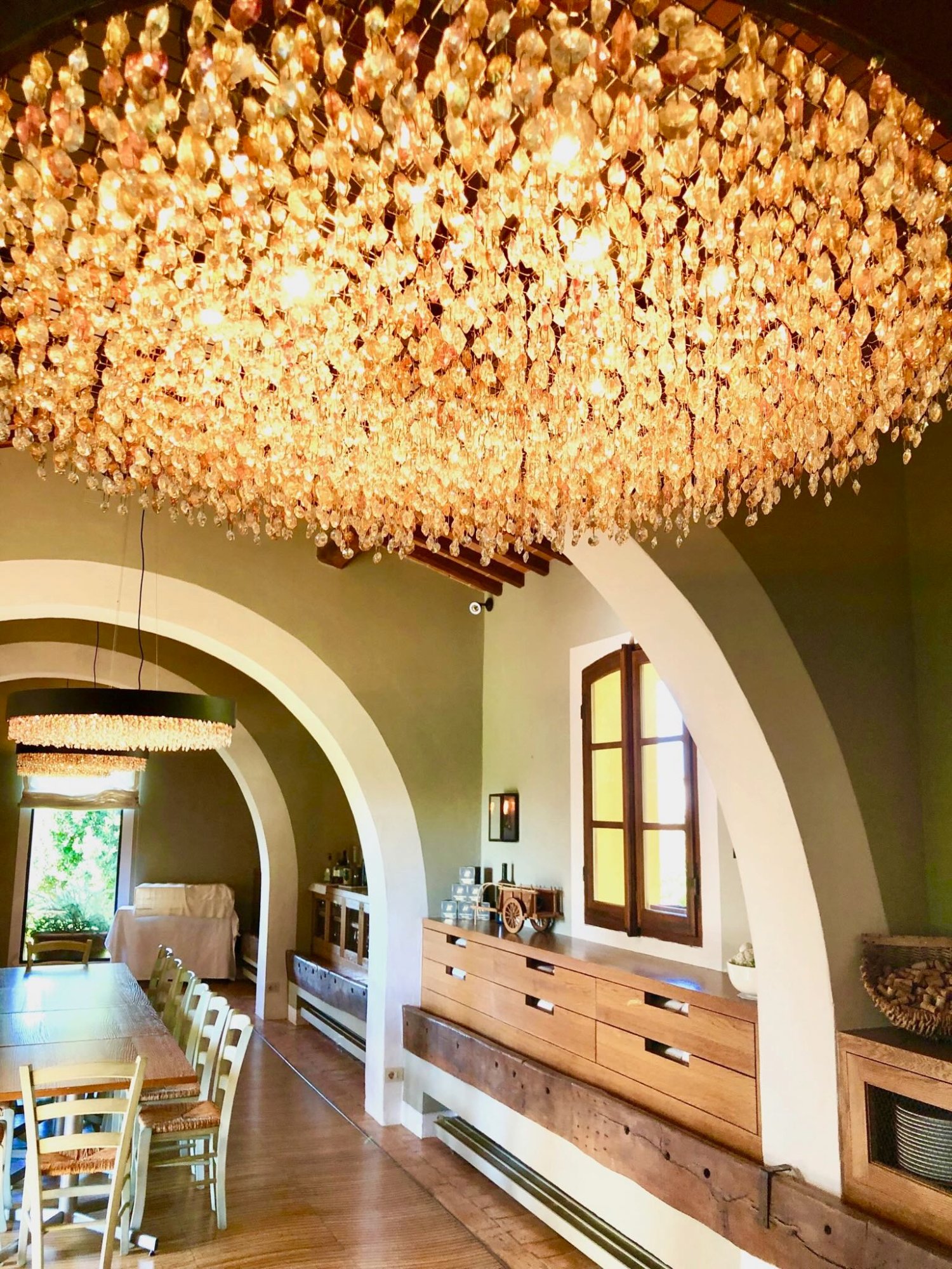 Avignonesi winery tasting room entrance with dramatic golden chandelier