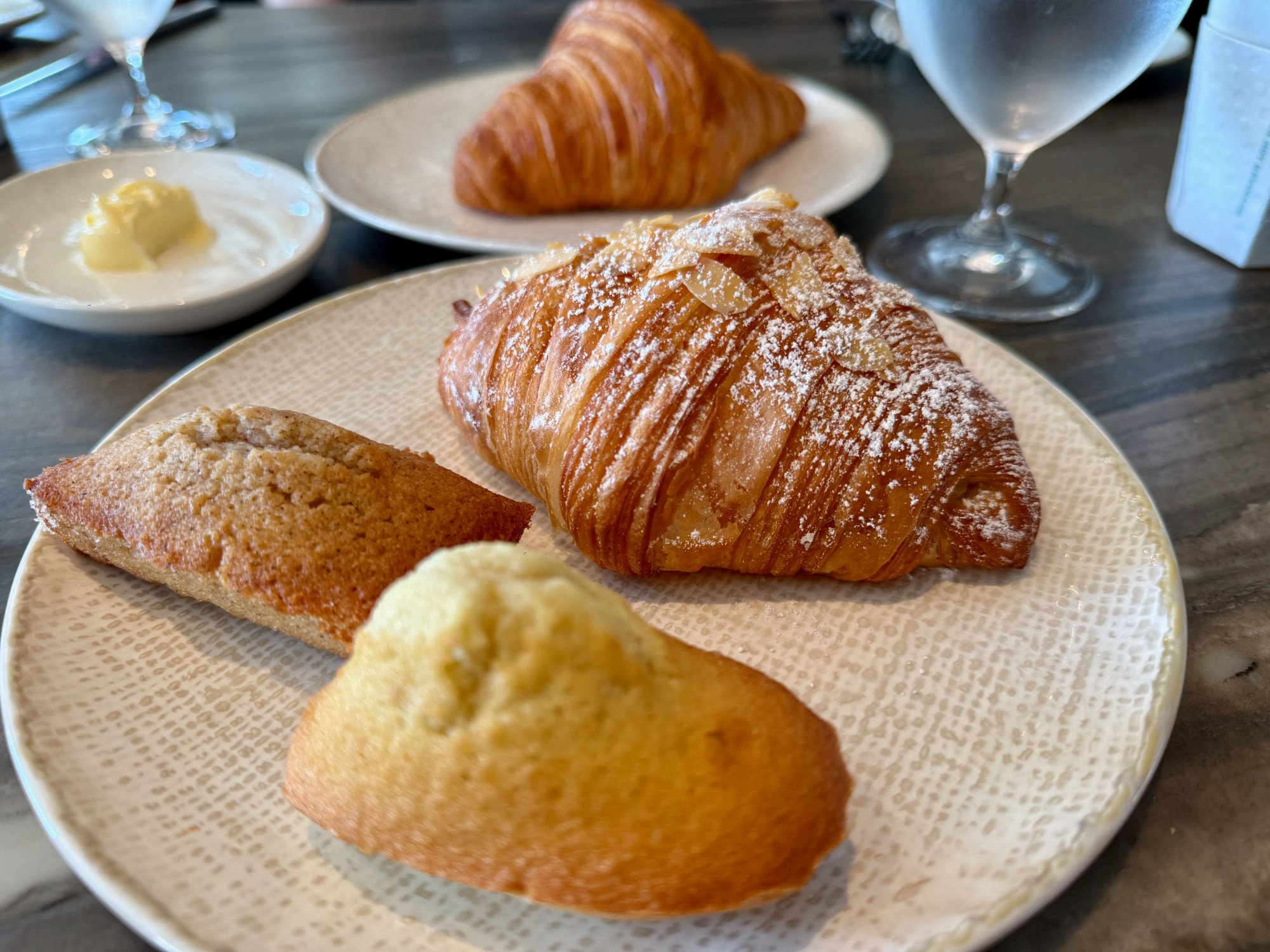 Le Grand Bistro pastries from the baker's oven — almond croissant, madeleine, financier