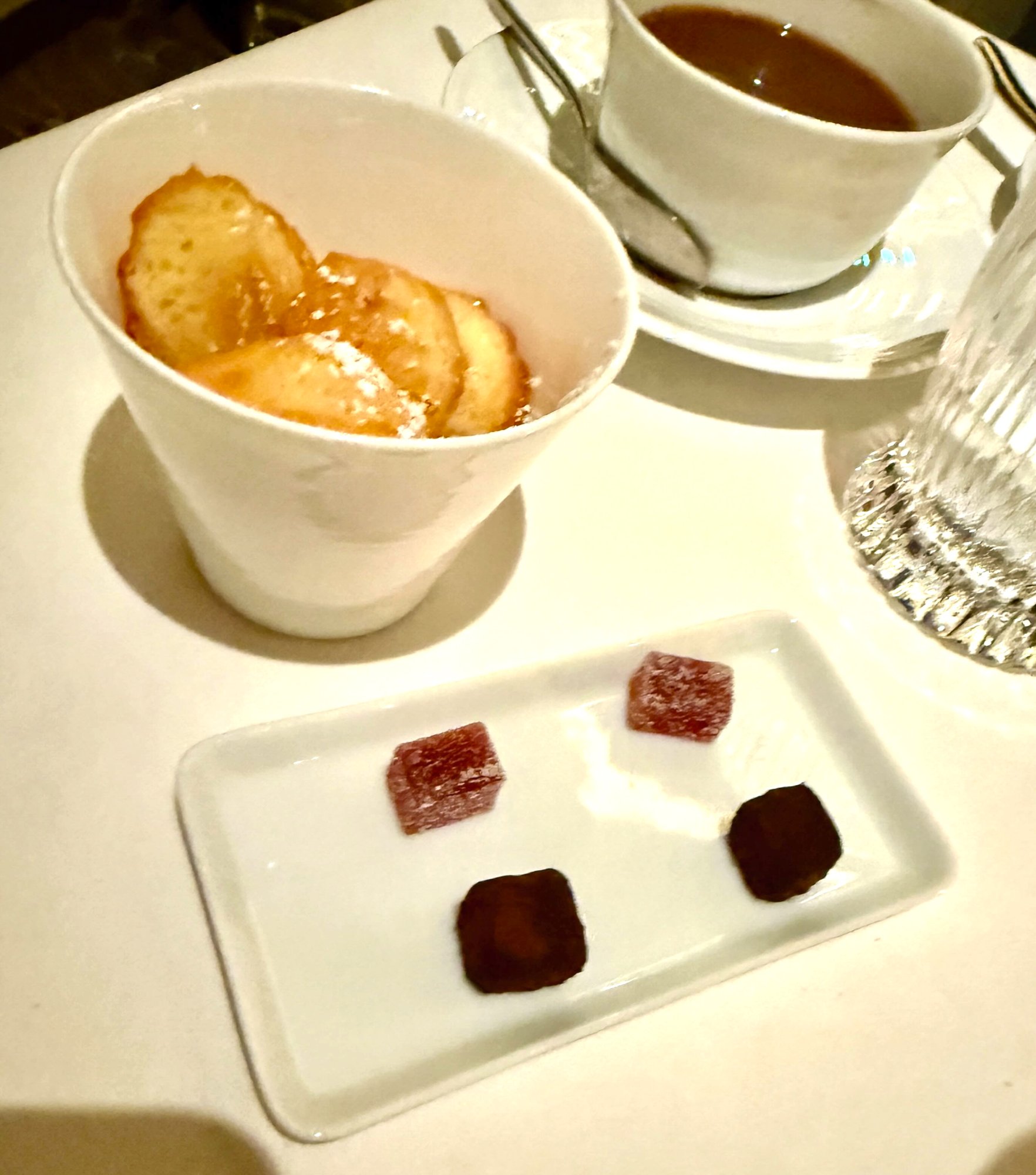 Le Voyage mignardises — warm madeleines and house-made truffles