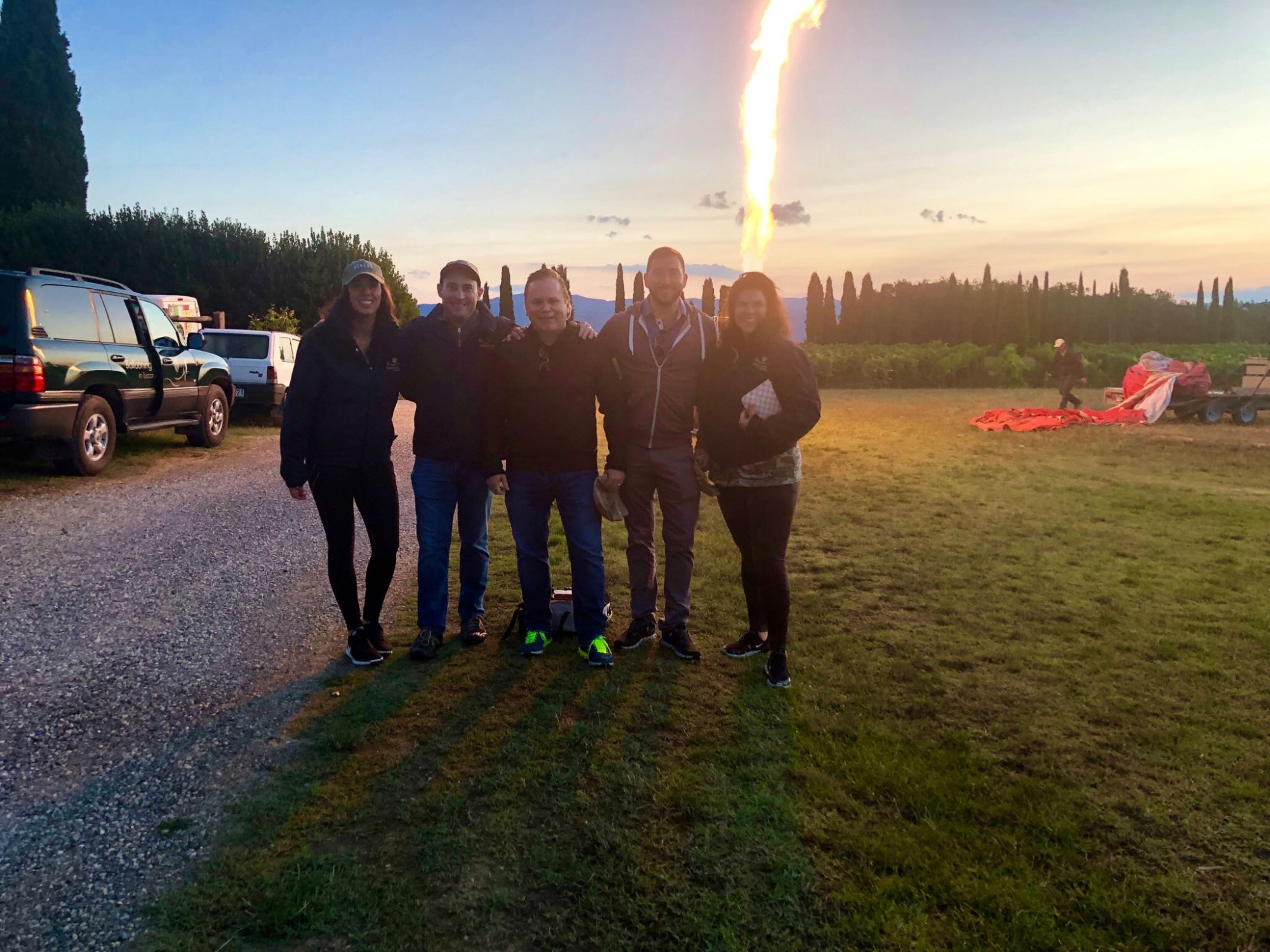 Group photo at sunrise before balloon launch over Tuscany