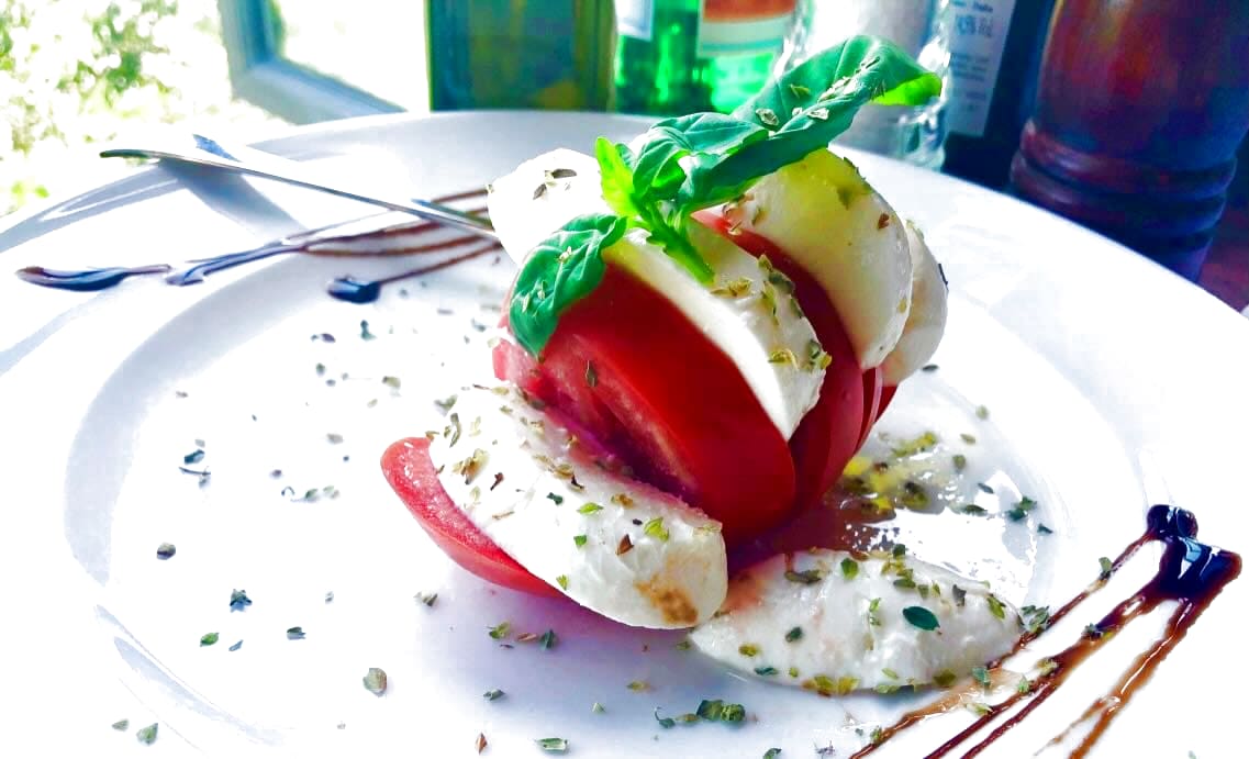 Traditional Tuscan caprese salad with fresh mozzarella and basil