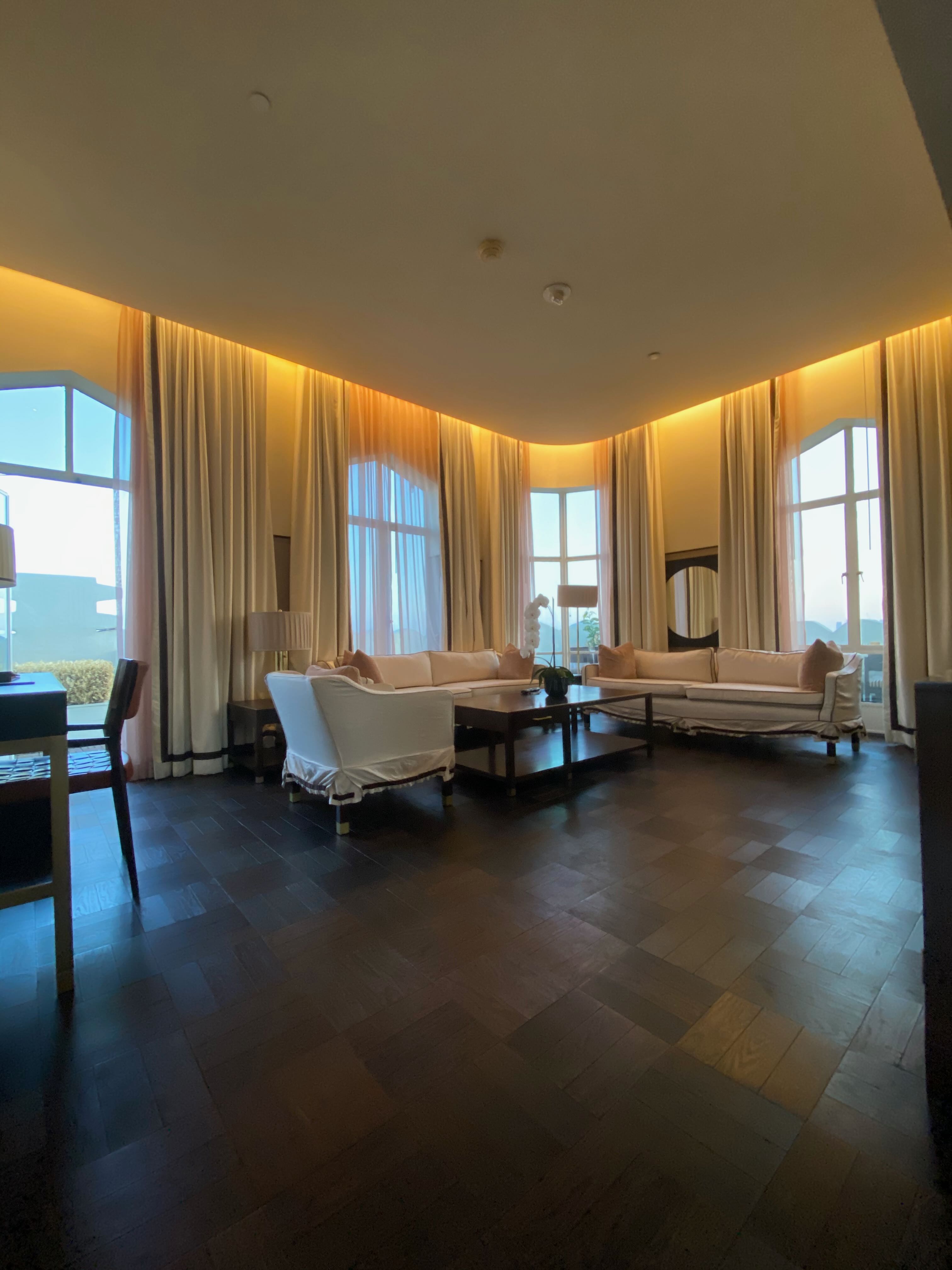 Sunset Tower penthouse living room — early evening golden light