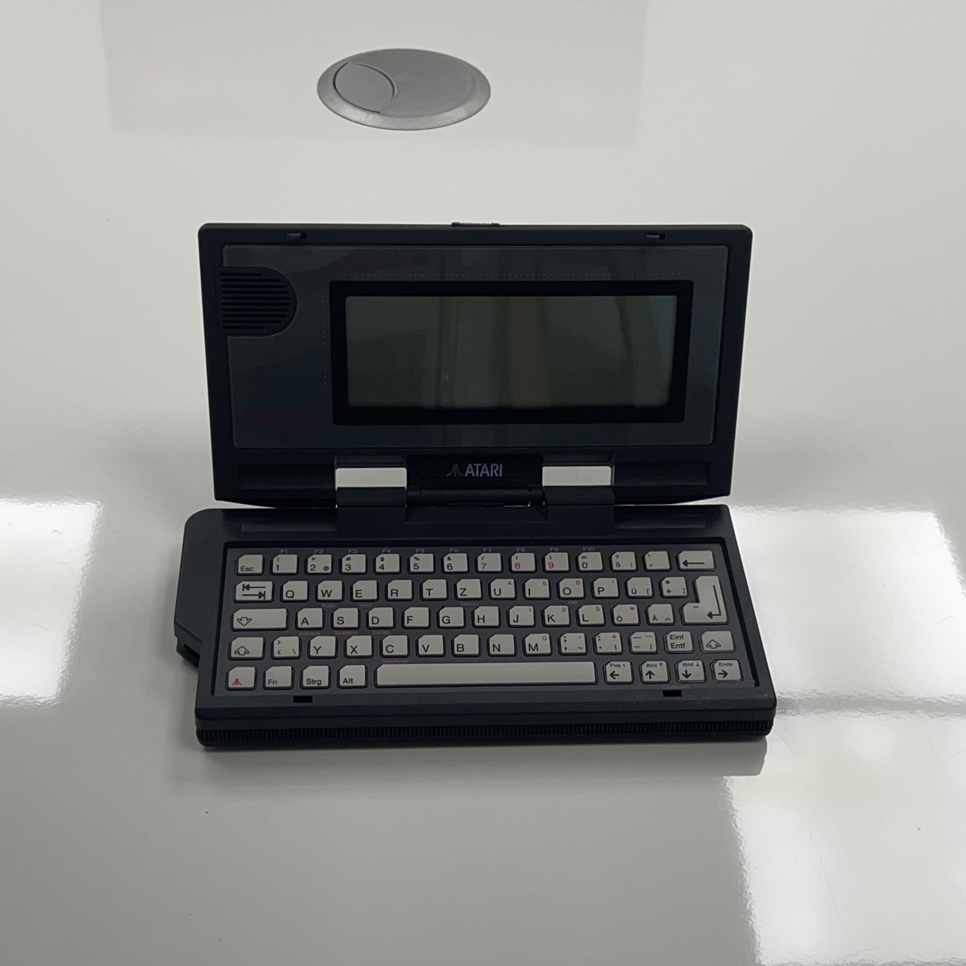 The Atari Portfolio, released in 1989, is one of the first truly portable MS-DOS–compatible computers. It uses a lightweight Intel 8088-compatible processor (the DIP-designed "CLDC") running at 4.91 MHz and includes built-in applications like a text editor and spreadsheet, all in a compact, battery-powered design.
