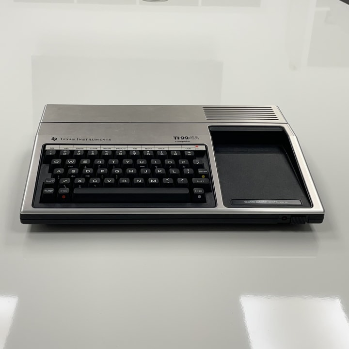 The Texas Instruments TI-99/4A, released in June 1981, was the first widely available 16-bit home computer, powered by a 3 MHz TMS9900 CPU and featuring 16 KB of RAM, a full-travel keyboard, and advanced graphics capabilities including sprite support and 16-color output. Despite its technical strengths, performance was hindered by an 8-bit architecture bottleneck, and intense price competition led to its discontinuation in 1984 after selling approximately 2.8 million units.