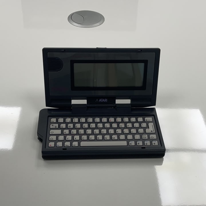 The Atari Portfolio, released in 1989, is one of the first truly portable MS-DOS–compatible computers. It uses a lightweight Intel 8088-compatible processor (the DIP-designed "CLDC") running at 4.91 MHz and includes built-in applications like a text editor and spreadsheet, all in a compact, battery-powered design.