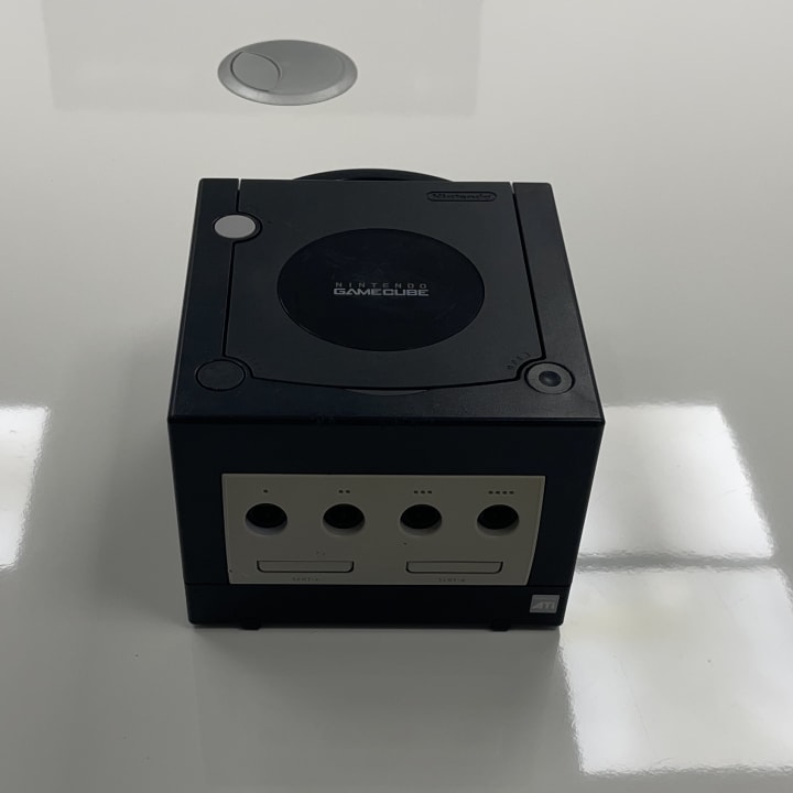 The Nintendo GameCube, released in 2001, is a sixth-generation console known for its compact design, distinctive handle, and a strong lineup of exclusive games like Super Smash Bros. Melee and The Legend of Zelda: The Wind Waker. It featured innovative mini-disc media and focused on multiplayer gaming experiences.