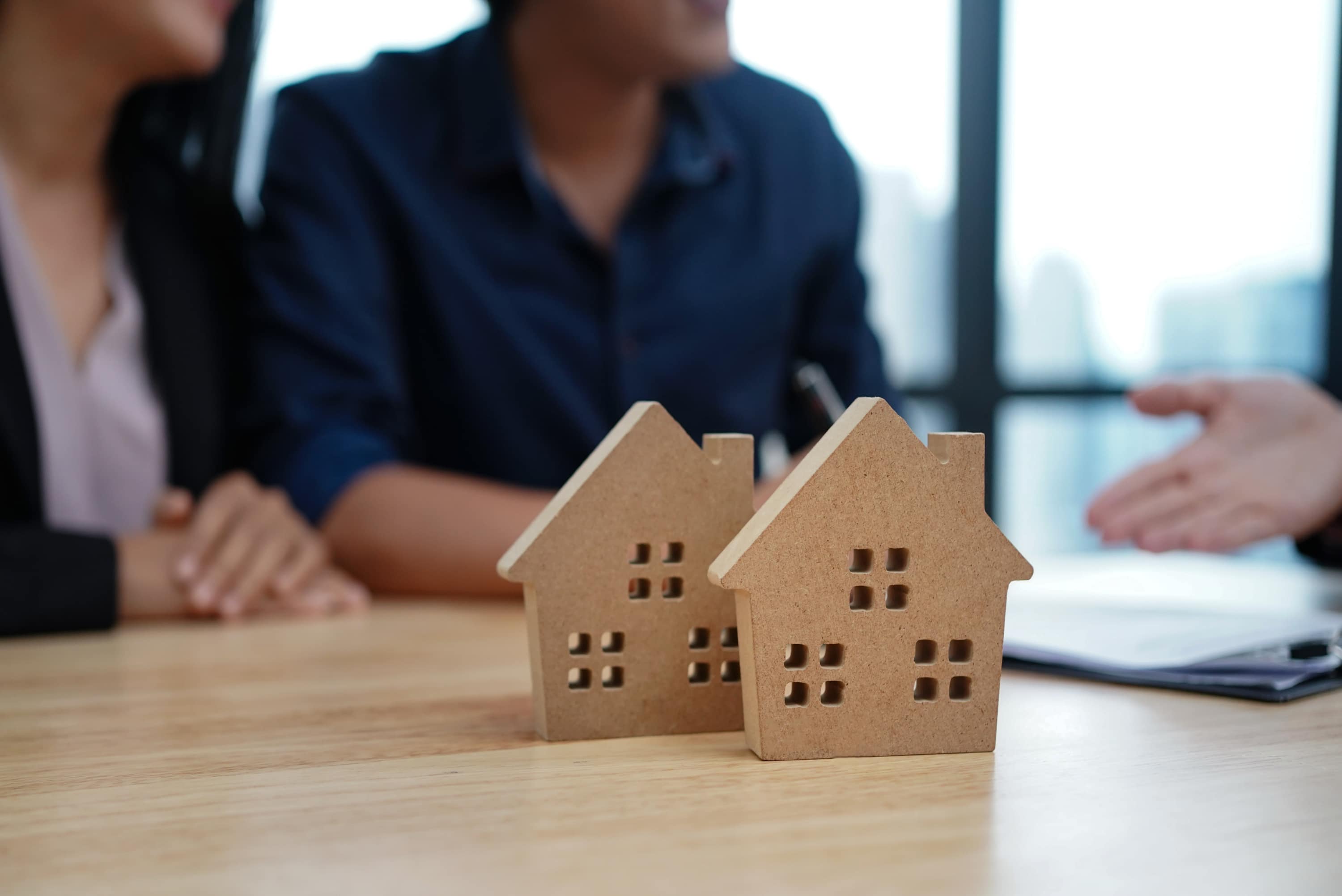 couple-behind-home-cutouts-completing-paperwork.jpg