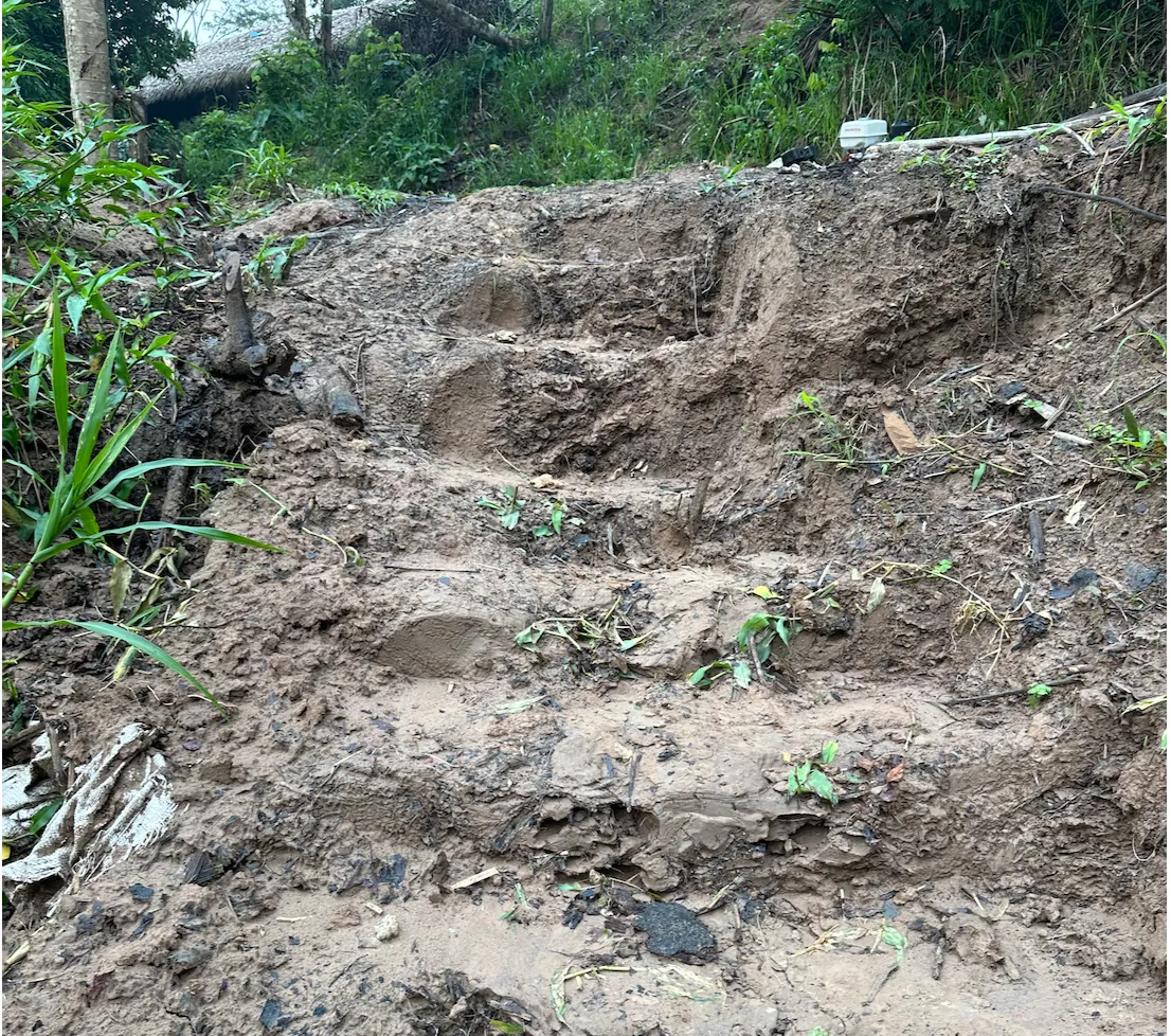 The muddy steps up to the village