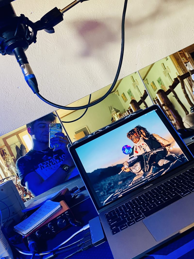 Justin shooting a MacBook screen on a studio set, condenser mic and audio interface visible