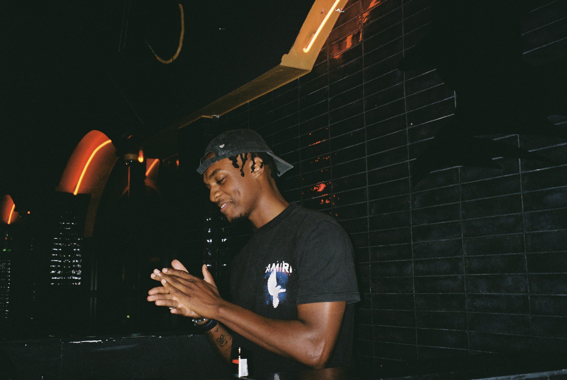 Close-up of DJ Challenge mid-performance at AfroSanctuary.