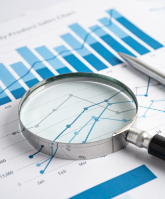 Business charts and magnifying glass