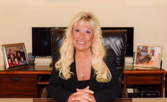 Susan Schauf smiling at her desk