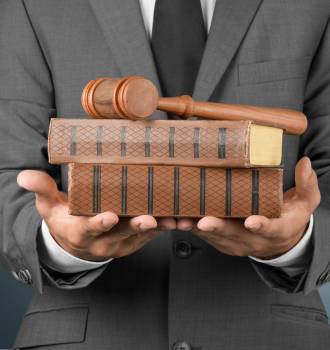 Man Holding Law Books and Gavel