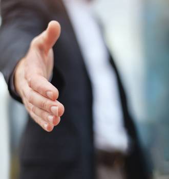 Man reaching toward the camera for a hand shake