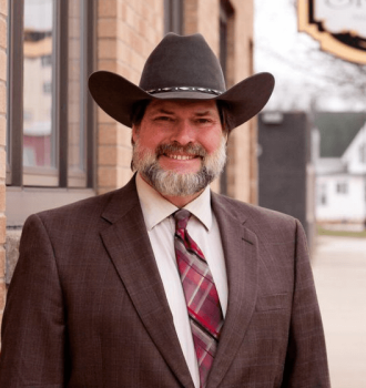 Ted Skemp smiling wearing his cowboy hat