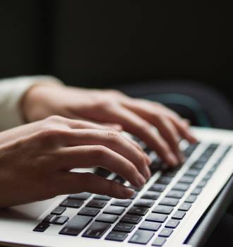 Woman typing on a laptop computer