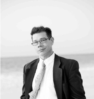 Attorney Anderson wearing a suit smiling