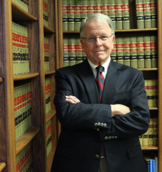 Attorney Fain Standing By the Bookshelves