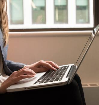 Woman typing at her computer