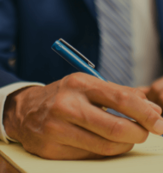 Attorney writing on notepad