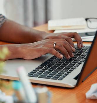 Woman typing at her computer