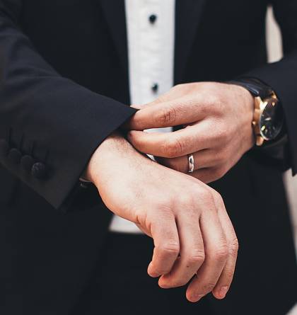 Businessman adjusting his cuffs on his sleeves