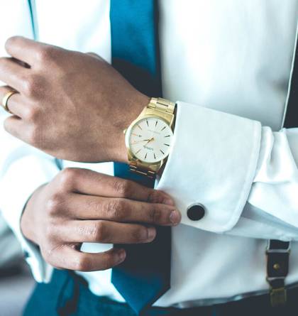 Businessman adjusting his cuffs on his sleeves