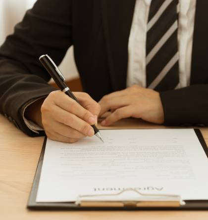 Man filling out agreement forms