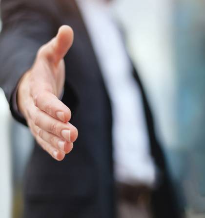 Man reaching toward the camera for a hand shake