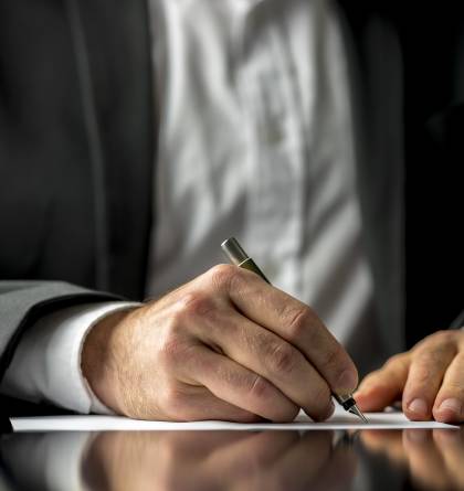 Man in suit writing