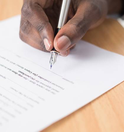 Man signing paperwork
