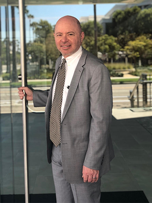 Attorney Alec Rose Opening a Glass Door