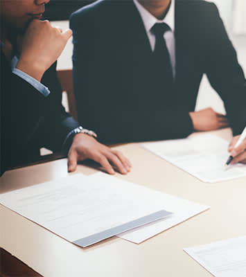 Two male attorneys look over documents