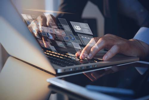 Businessman typing on computer looking at reviews and performance