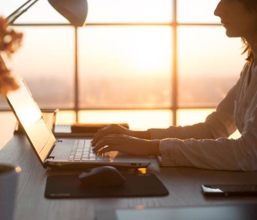 person typing on laptop