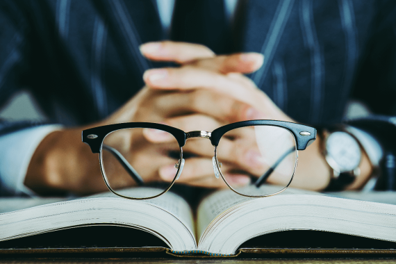 Glasses Resting on Open Book