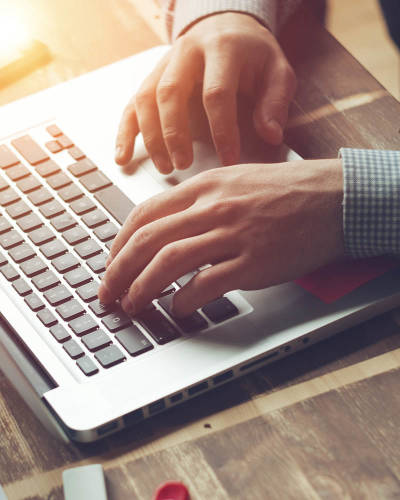 Close up of hands working on a computer