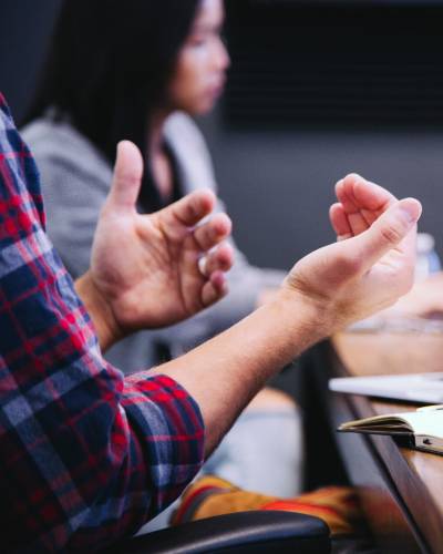 Two people in a meeting with one explaining something
