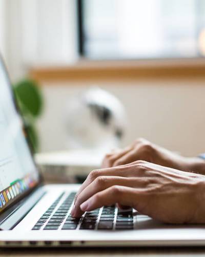 Man typing at computer