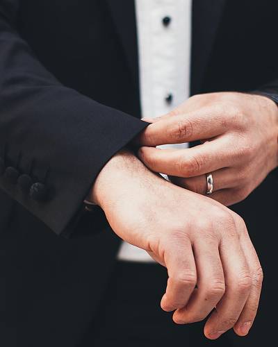Man in suit adjusting his sleeves