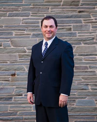 Peter standing outside in a suit