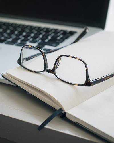 Desk with notebook and glasses